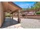 Covered patio with ceiling fan, landscaping with shrubbery and stone features in backyard at 636 Pacific Cascades Dr, Henderson, NV 89012