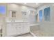 Bright bathroom with dual sink vanity and a glass enclosed shower with a built in bench at 636 Pacific Cascades Dr, Henderson, NV 89012