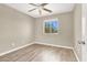 Neutral bedroom features a ceiling fan and a window that overlooks the backyard at 636 Pacific Cascades Dr, Henderson, NV 89012