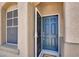Inviting entryway featuring a blue front door, and a storm door, allowing natural light to fill the space at 636 Pacific Cascades Dr, Henderson, NV 89012