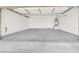 Spacious garage with white walls, concrete flooring, and built-in shelving at 636 Pacific Cascades Dr, Henderson, NV 89012