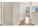 Hallway with wood-look floors leading into bedrooms and a neutral color palette at 636 Pacific Cascades Dr, Henderson, NV 89012