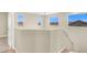 Hallway with multiple windows offers views of the red tile roofs outside at 636 Pacific Cascades Dr, Henderson, NV 89012