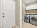 Laundry room featuring side by side washer and dryer with a decorative tile backsplash at 636 Pacific Cascades Dr, Henderson, NV 89012