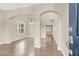 Open-concept living room with beautiful hardwood floors and arched doorways, creating a seamless flow at 636 Pacific Cascades Dr, Henderson, NV 89012