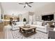 Open-concept living space with a spacious layout, hardwood floors, and seamless connection to the modern kitchen at 636 Pacific Cascades Dr, Henderson, NV 89012
