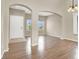 Spacious living room featuring wood floors, neutral paint, and an archway to other rooms at 636 Pacific Cascades Dr, Henderson, NV 89012