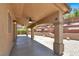 Covered patio with landscaped yard features a ceiling fan, arches and pillars at 636 Pacific Cascades Dr, Henderson, NV 89012