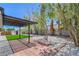Landscaped backyard features a stone border, gravel, brick, and turf at 6517 Villa Mesa Dr, Las Vegas, NV 89107