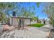 View of backyard with turf, storage shed, and brick and gravel accents at 6517 Villa Mesa Dr, Las Vegas, NV 89107