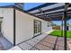 Backyard view showcasing a pergola, artificial grass, and brick-lined gravel at 6517 Villa Mesa Dr, Las Vegas, NV 89107