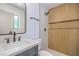 Modern bathroom with light wood accent wall, stylish fixtures, and a glass-enclosed shower at 6517 Villa Mesa Dr, Las Vegas, NV 89107
