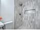 A modern bathroom featuring a shower with a built-in toiletry space, and mosaic tile flooring at 6517 Villa Mesa Dr, Las Vegas, NV 89107