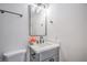 Stylish bathroom featuring a gray vanity, modern mirror, and neutral wall paint at 6517 Villa Mesa Dr, Las Vegas, NV 89107