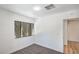 Bright bedroom features plush carpet, a window with backyard view, and leads to additional rooms at 6517 Villa Mesa Dr, Las Vegas, NV 89107