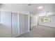 Bedroom featuring sliding closets, a ceiling fan, and a large window for natural light at 6517 Villa Mesa Dr, Las Vegas, NV 89107