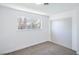 Bright bedroom features plush carpeting, a window view, and a mirrored closet at 6517 Villa Mesa Dr, Las Vegas, NV 89107
