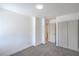 A well-lit bedroom featuring neutral carpeting, closet and access to another room at 6517 Villa Mesa Dr, Las Vegas, NV 89107