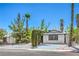Home with trees, gravel landscaping, a paved driveway, and easy street access at 6517 Villa Mesa Dr, Las Vegas, NV 89107