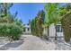 Home with gravel landscaping, mature hedges, and a paved driveway at 6517 Villa Mesa Dr, Las Vegas, NV 89107
