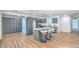 Bright kitchen features gray cabinets, island with seating, stainless appliances, and hardwood-style flooring at 6517 Villa Mesa Dr, Las Vegas, NV 89107