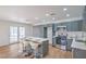 Updated kitchen has gray cabinets, stainless steel appliances, white quartz counters, and island seating at 6517 Villa Mesa Dr, Las Vegas, NV 89107