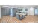 Modern kitchen with gray cabinets, stainless steel appliances, and a sleek island with bar seating at 6517 Villa Mesa Dr, Las Vegas, NV 89107