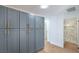 Hallway with modern cabinets and a glimpse into a bathroom with decorative tiles and a shower at 6517 Villa Mesa Dr, Las Vegas, NV 89107