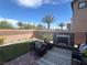 Cozy backyard patio featuring a stone fireplace and comfortable seating under sunny skies at 6682 Salt Pond Bay St, Las Vegas, NV 89149