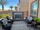 Cozy backyard patio features a stone fireplace and comfortable seating arrangement at 6682 Salt Pond Bay St, Las Vegas, NV 89149