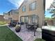 Backyard patio features a dining table and chairs, a built-in grill, and manicured lawn at 6682 Salt Pond Bay St, Las Vegas, NV 89149