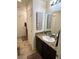 Bathroom with tiled floors, granite countertops, and a dark wood vanity at 6682 Salt Pond Bay St, Las Vegas, NV 89149