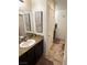 Bathroom showcasing granite countertops, a dark wood vanity, and tiled flooring at 6682 Salt Pond Bay St, Las Vegas, NV 89149
