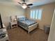 Well-lit bedroom with carpeted floors, a ceiling fan, and plantation shutters on the window at 6682 Salt Pond Bay St, Las Vegas, NV 89149