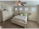 Bright bedroom with ceiling fan, carpeted floors, and three windows with shutter blinds at 6682 Salt Pond Bay St, Las Vegas, NV 89149