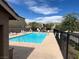Bright community pool area with ample lounge chairs and a secure fence at 6682 Salt Pond Bay St, Las Vegas, NV 89149
