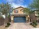 Two-story home with a large blue garage door and a charming desert landscape at 6682 Salt Pond Bay St, Las Vegas, NV 89149