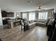 Open-concept living space with a large sectional couch and modern finishes at 6682 Salt Pond Bay St, Las Vegas, NV 89149