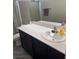 Bathroom features a toilet, single sink vanity with black cabinets, a white countertop, and neutral colored walls at 6867 Dragonfly Rock St, Las Vegas, NV 89148