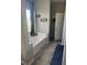 Bright bathroom featuring a soaking tub with a window view and tiled floors at 6867 Dragonfly Rock St, Las Vegas, NV 89148