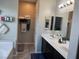 Dual sink vanity with dark cabinets and tile flooring, offering a relaxing space at 6867 Dragonfly Rock St, Las Vegas, NV 89148