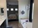 Bathroom view featuring a tub and decor, connecting to the bedroom with carpeted floors at 6867 Dragonfly Rock St, Las Vegas, NV 89148