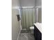 Bathroom featuring a toilet, a single sink vanity with black cabinets, and a shower with a neutral-toned curtain at 6867 Dragonfly Rock St, Las Vegas, NV 89148