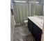 Bathroom featuring a toilet, a double sink vanity with black cabinets, and a shower with a neutral-toned curtain at 6867 Dragonfly Rock St, Las Vegas, NV 89148