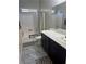 Bathroom featuring a toilet, a double sink vanity with black cabinets, and a shower-tub combo at 6867 Dragonfly Rock St, Las Vegas, NV 89148