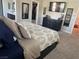 Bedroom features carpeted floors, black dresser, a TV, and ensuite bathroom and closet entries at 6867 Dragonfly Rock St, Las Vegas, NV 89148