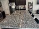 A kitchen featuring granite countertops, stainless steel appliances, and dark wood cabinetry at 6867 Dragonfly Rock St, Las Vegas, NV 89148