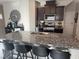Kitchen features a granite countertop island with bar stool seating, stainless appliances and dark wood cabinetry at 6867 Dragonfly Rock St, Las Vegas, NV 89148