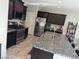 Beautiful kitchen with stainless steel appliances, dark cabinets, and granite countertops with barstool seating at 6867 Dragonfly Rock St, Las Vegas, NV 89148