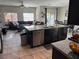 Open-concept living space featuring a spacious seating area, a dining table, and a large kitchen island at 6867 Dragonfly Rock St, Las Vegas, NV 89148